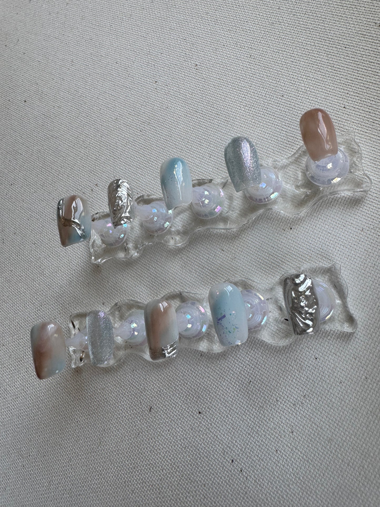 Tidal Light – Nude & Blue Chrome Cat Eye Nails with Water Ripples