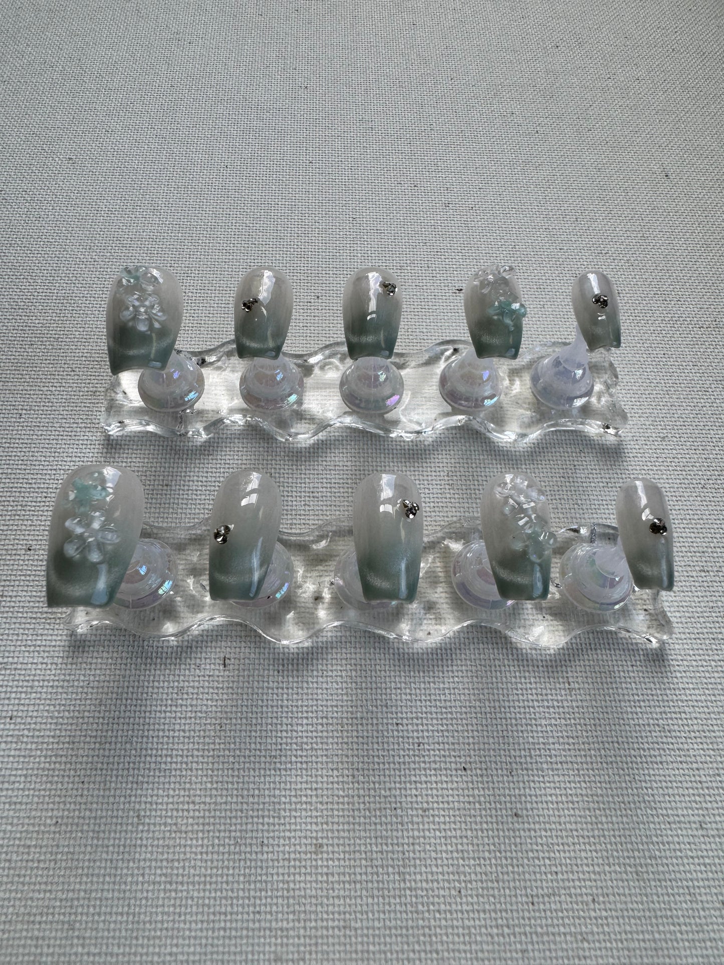 Floral Dew – 3D Blossoms on Pastel Green Crystal With Cat Eye Nails