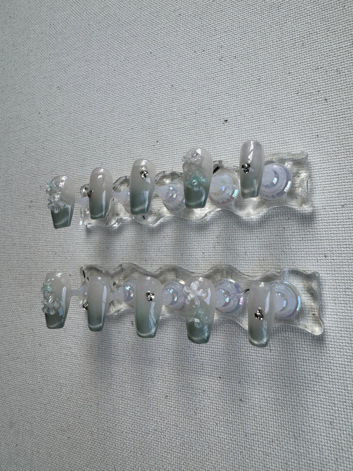 Floral Dew – 3D Blossoms on Pastel Green Crystal With Cat Eye Nails