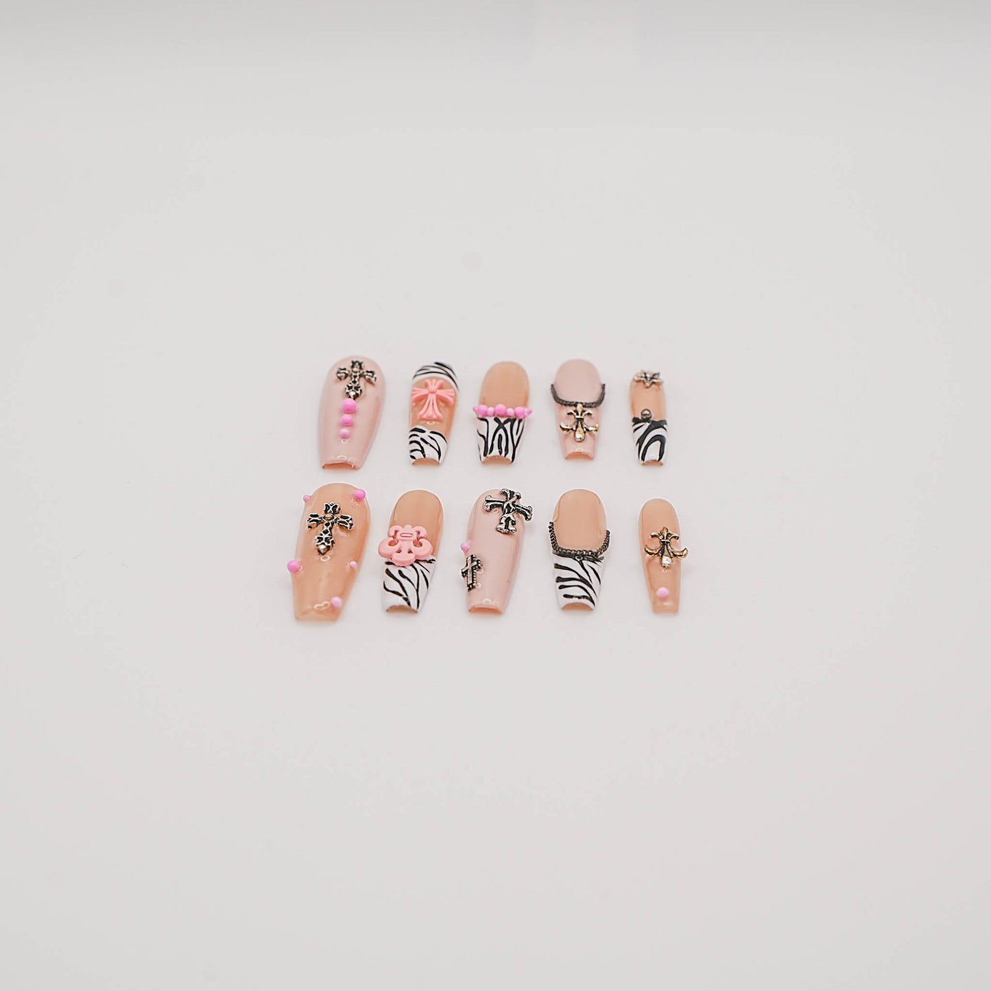 Zebra Punk Press-On Nails – Nude & Black Y2K Style with Cross Charms & Pink Accents