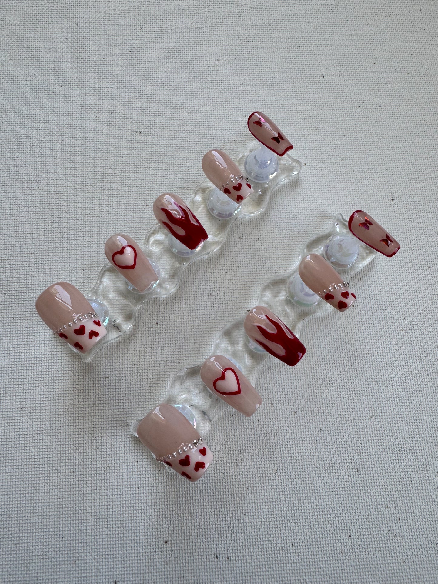 Burning Sweet – Nude French with Flame Hearts & Butterfly Charms
