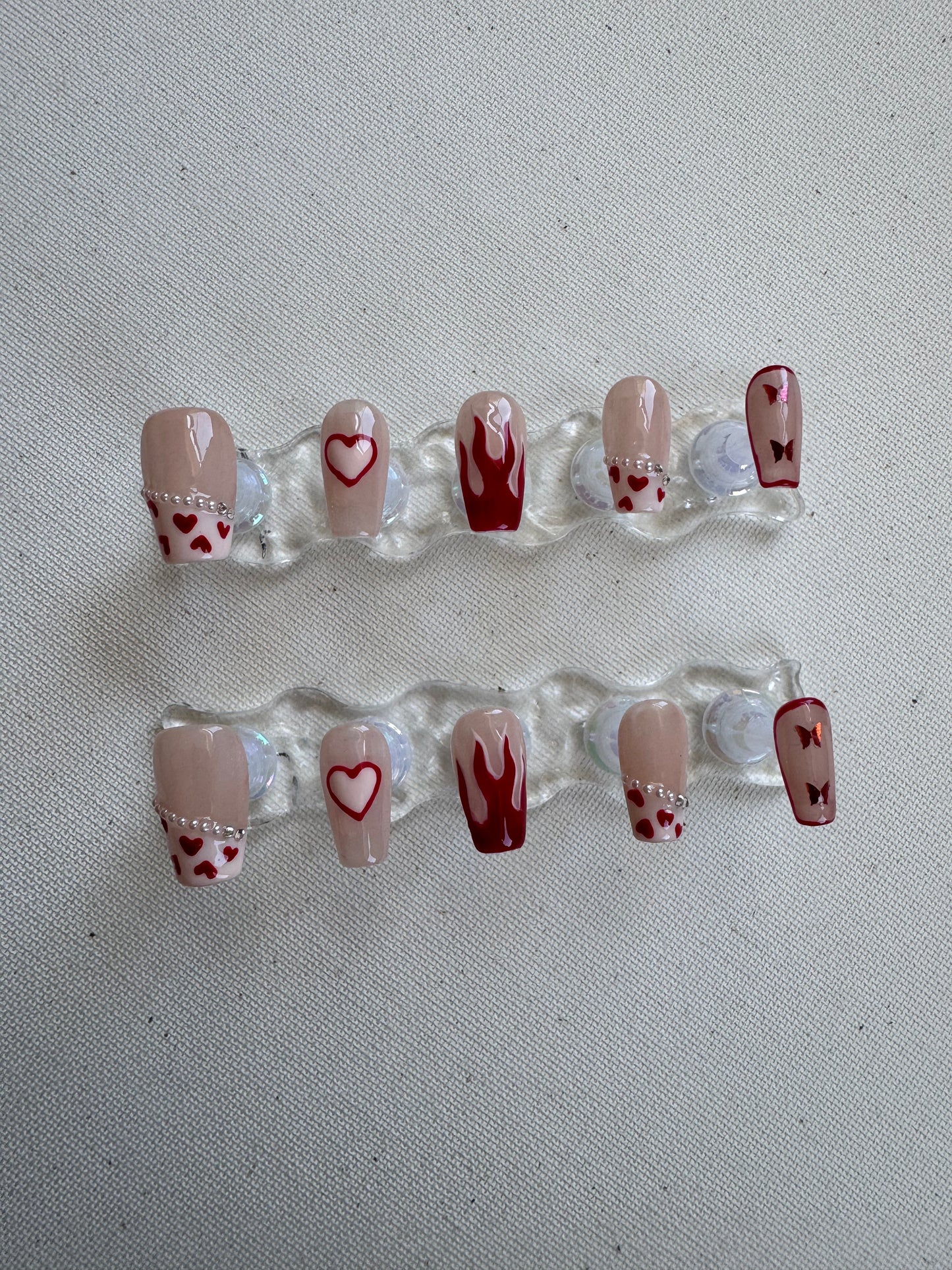 Burning Sweet – Nude French with Flame Hearts & Butterfly Charms