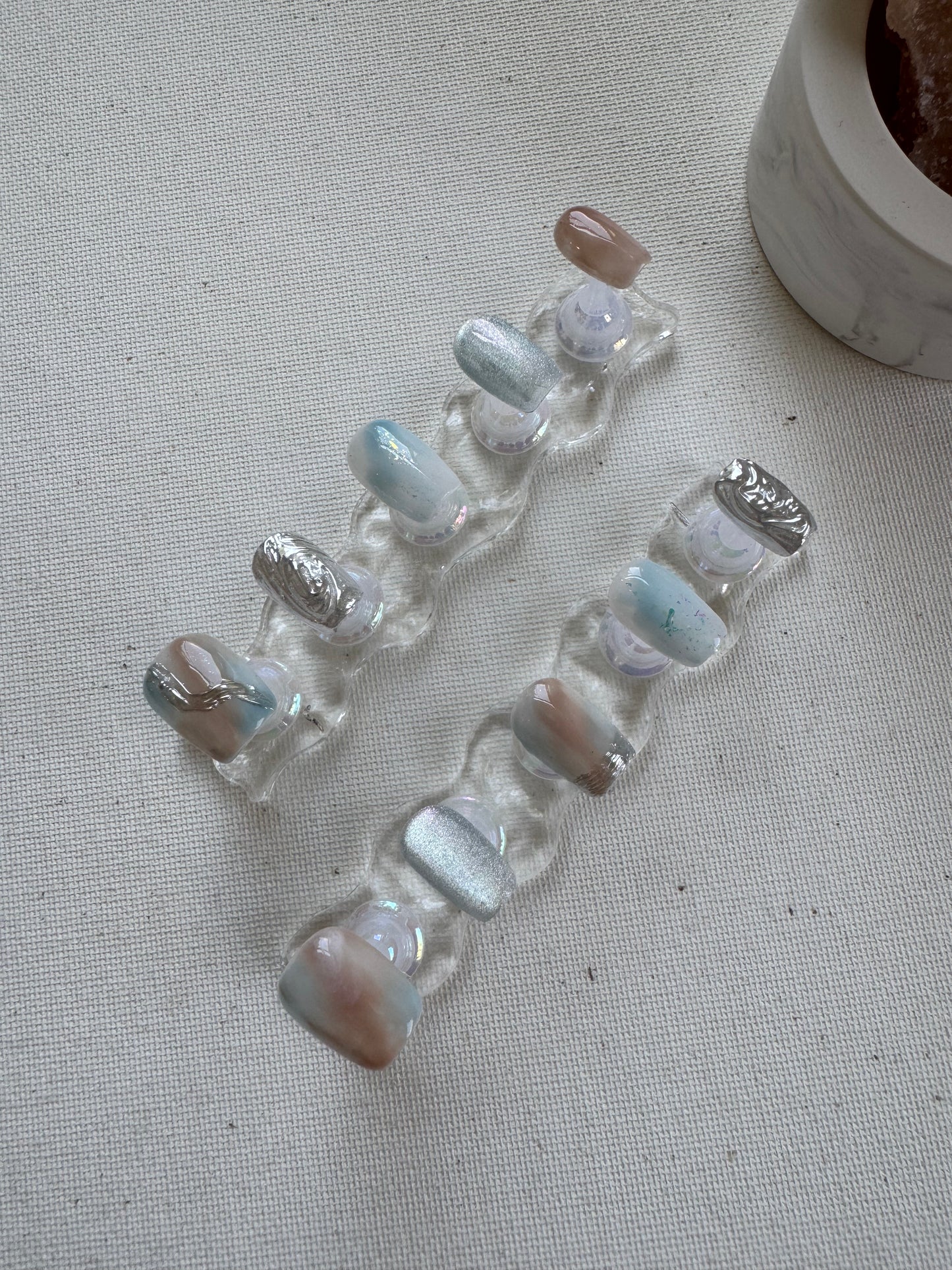 Tidal Light – Nude & Blue Chrome Cat Eye Nails with Water Ripples