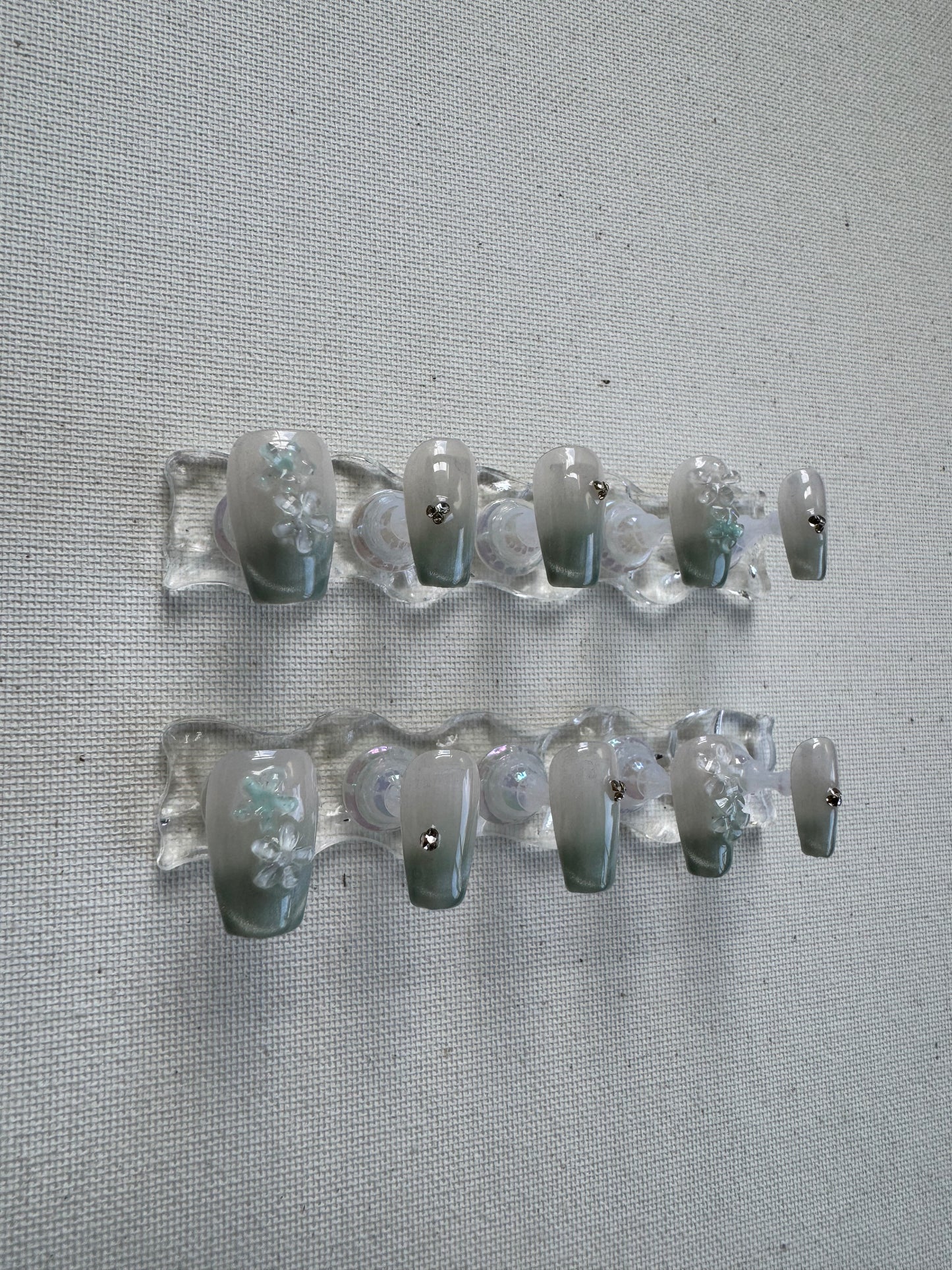 Floral Dew – 3D Blossoms on Pastel Green Crystal With Cat Eye Nails