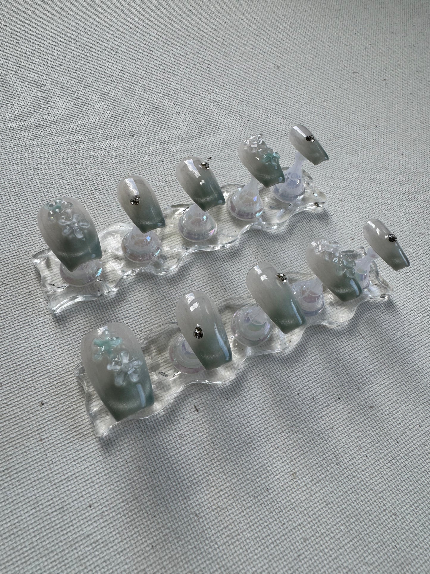 Floral Dew – 3D Blossoms on Pastel Green Crystal With Cat Eye Nails